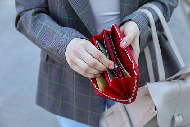 istock Woman holding purse with banknotes outdoors, closeup 2226850715