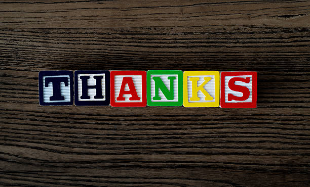 Wooden blocks with word thanks.