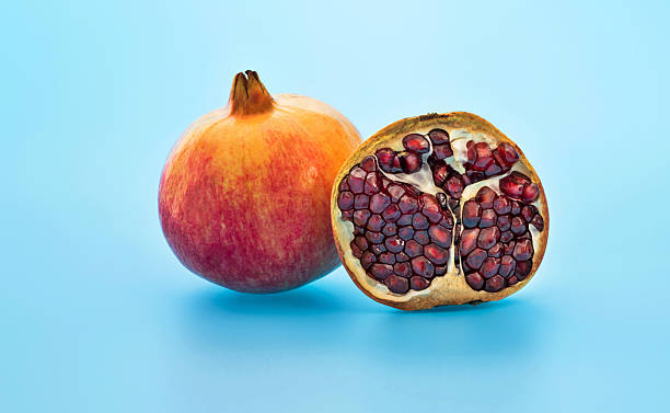 One and a half pomegranates on red background