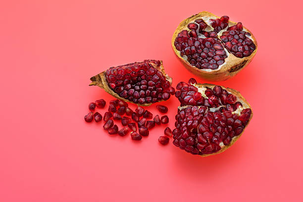 istock Pieces of pomegranate on red background 2226852239