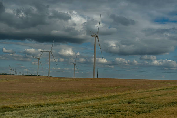 Reims, France - 06 26 2025: Panoramic view of a landscape with wind turbines and cloudy sky behind