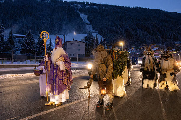 istock Costumed figures participate in a winter celebration in the mountains at dusk 2226854619