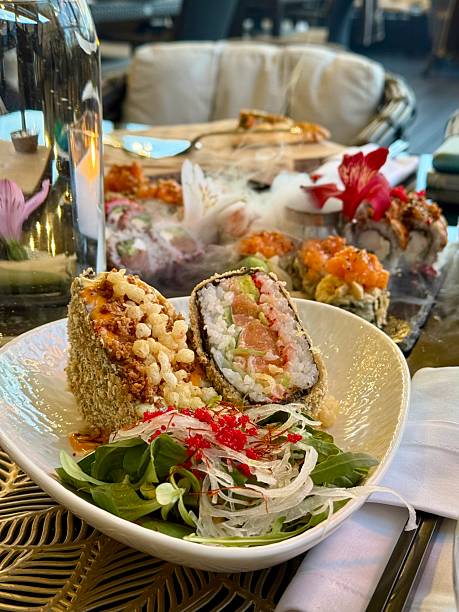 Gourmet Sushi Rolls with Fresh Greens and Decorative Plating in Upscale Restaurant