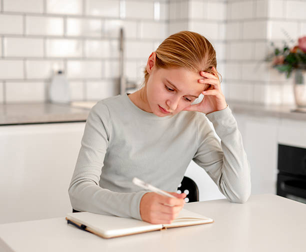 istock Cute Little Girl Doing Homework 2226861783