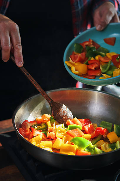 Preparing Rigatoni Pasta with Blue Mussels and Mixed Peppers in Domestic Kitchen