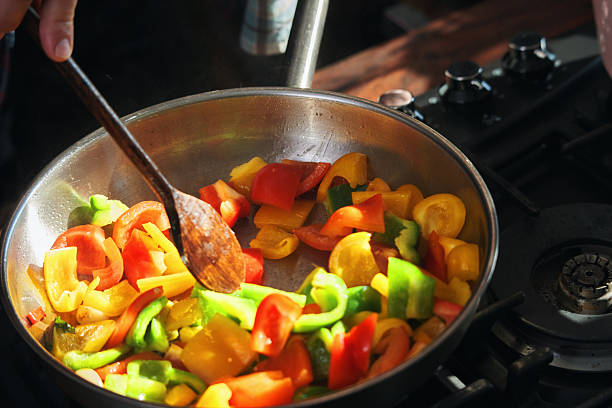Preparing Rigatoni Pasta with Blue Mussels and Mixed Peppers in Domestic Kitchen