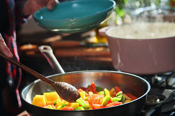 Preparing Rigatoni Pasta with Blue Mussels and Mixed Peppers in Domestic Kitchen