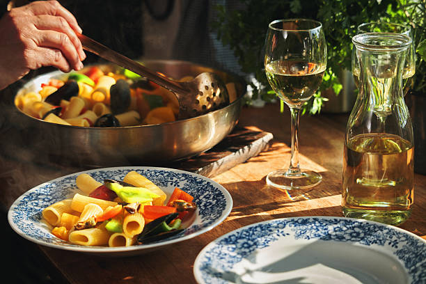 Preparing Rigatoni Pasta with Blue Mussels and Mixed Peppers in Domestic Kitchen