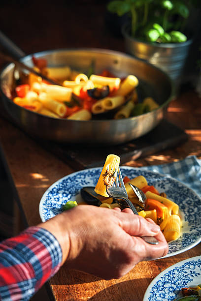Rigatoni Pasta with Blue Mussels and Mixed Peppers in Domestic Kitchen