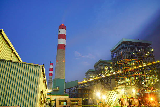 istock Industrial landscape featuring power plant with illuminated structures at twilight 2226863166