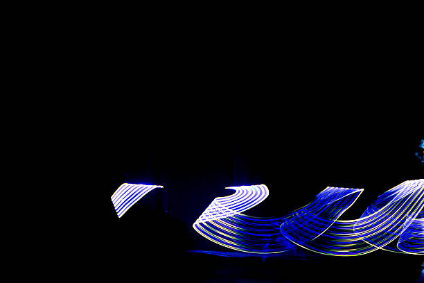 istock Abstract light painting with dynamic, neon trails against a stark black background creating a 2226863226