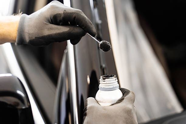 istock Applying primer on car frame before windshield installation. Applying black primer on car frame ensures strong adhesion. Essential preparation step for long-lasting and safe auto glass sealing. 2226864579