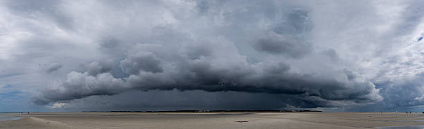 istock A so-called roll cloud, the harbinger of a coming thunderstorm, moves over the mudflats at low tide on the North Frisian island of Föhr in the North Sea 2226865907