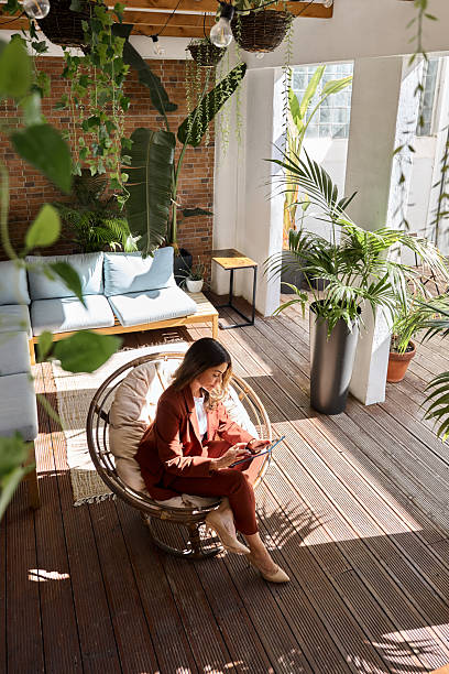 istock Middle aged business woman using tablet in sunny green office. Vertical. 2226866428