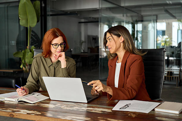 istock Two busy female coworkers working together using computer at desk in office. 2226866438