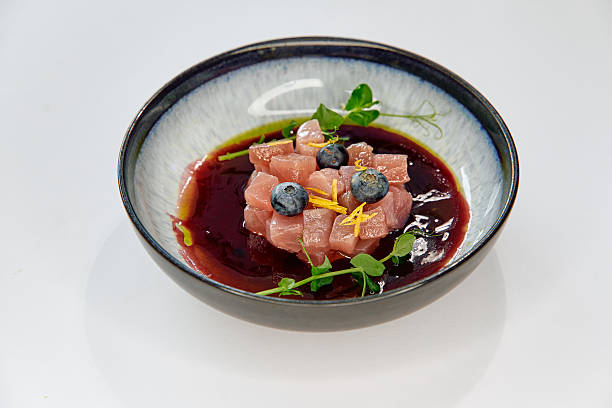 istock Delicately Plated Culinary Masterpiece Featuring Fresh Tuna Cubes with Blueberries and Microgreens in a Rich Berry Sauce 2226868119