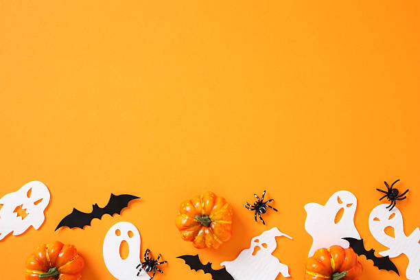 istock Halloween flat lay on vibrant orange background: pumpkins, black bats, white ghosts, and spiders evoke spooky charm 2226868191