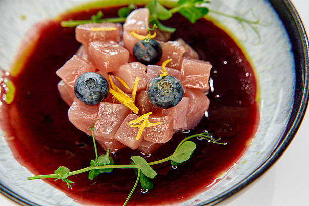 istock An Exquisite Culinary Creation Featuring Fresh Tuna Cubes Garnished with Blueberries and Citrus Zest on a Rich Berry Reduction Sauce 2226868270