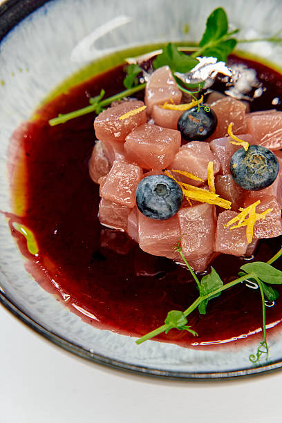 istock A Deliciously Crafted Dish Featuring Diced Fish, Fresh Blueberries, and Vibrant Sauce Garnished with Herbs and Zesty Citrus Flavors 2226868496