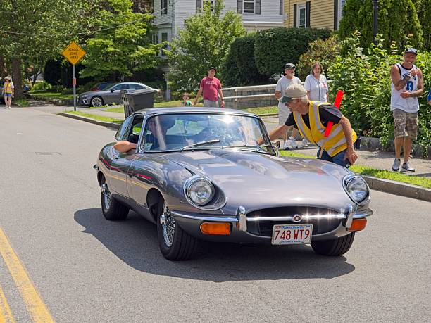 A Silver Jaguar E-Type Series 3 V12 Open Two-Seater from 1973 on the streets of Schenna, South Tyrol.