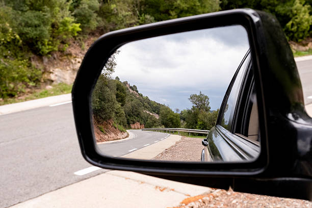 istock Road through the rearview mirror. 2226869353