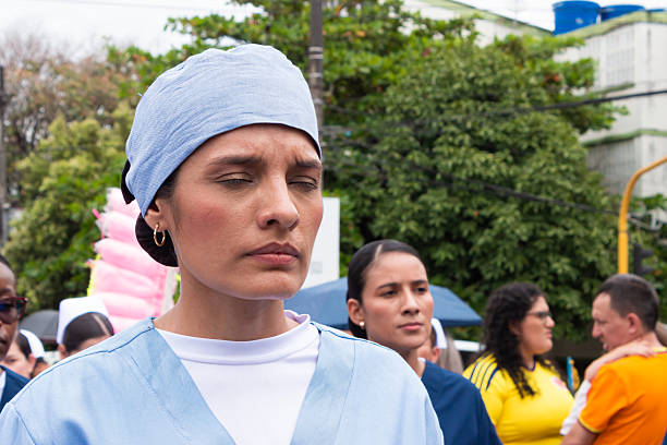 Neiva, Huila, Colombia - July 20, 2025  A military nurse in uniform with her eyes closed is marching in the military parade on Independence Day