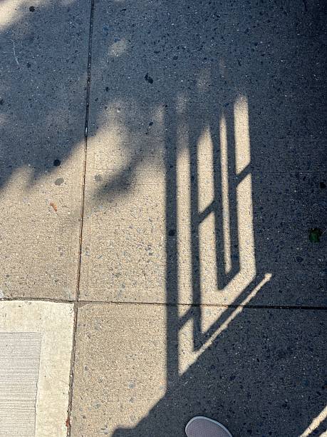 istock Shadows on sidewalk of geometric fence on Brooklyn stoop 2226876586