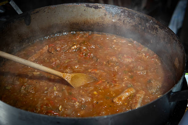 istock Stirring a rich, savory meat sauce in a large pot 2226878657