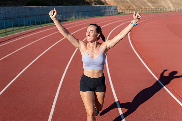 istock Young female athlete celebrating winning on running track 2226881968