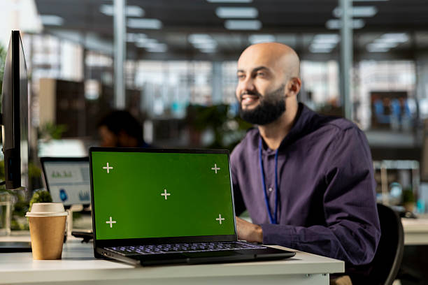 istock Middle eastern general manager sitting at desk next to green screen on pc 2226882092
