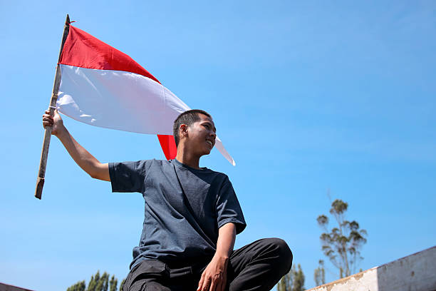 istock Man Waving Indonesian Flag 2226883306