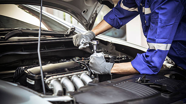 istock Car care maintenance and servicing, Close-up hand technician auto mechanic using the wrench to repairing change spare part car engine problem and car insurance service support. 2226885350