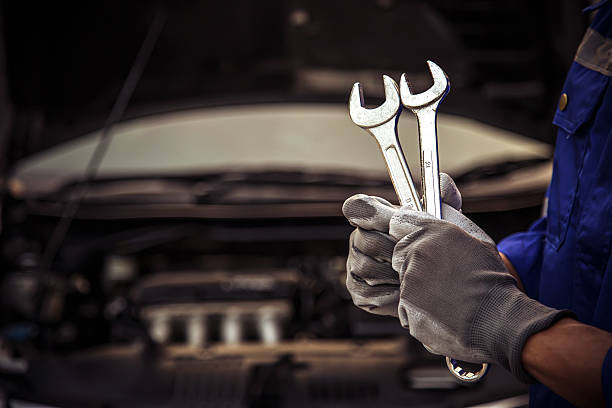 Car care maintenance and servicing, Close-up hand technician auto mechanic using the wrench to repairing change spare part car engine problem and car insurance service support.