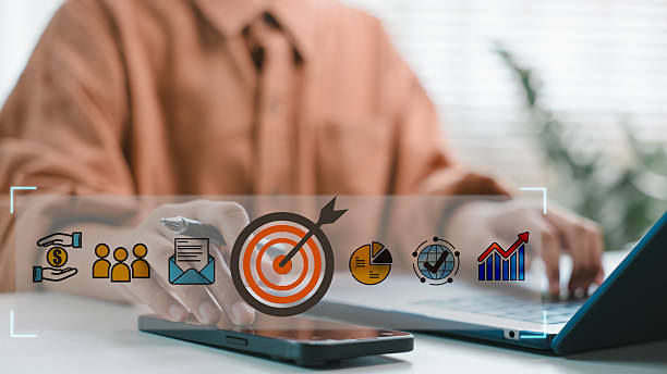 istock A businessman using a laptop and smartphone with a target marketing icon on a digital interface. Concept of business strategy, goal setting, and digital marketing analytics. 2226886261
