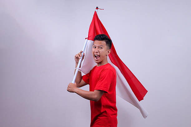 istock Indonesian Man Waving Red And White Flag 2226895698
