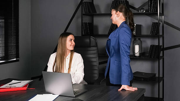 istock Professional women engage in discussion in a modern office setting during work hours 2226896342