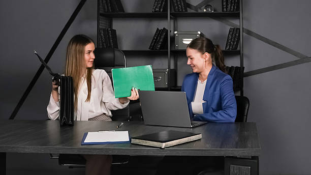 istock Two business professionals collaborating in a modern office setting during a meeting 2226896551