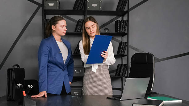 istock Two professionals discuss project details in a modern office setting during the afternoon 2226897043