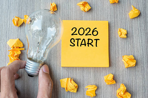 istock 2026 Start words on yellow note and crumbled paper with Businessman holding lightbulb on wooden table background. New Year New Idea Creative, Innovation, Imagination, Resolution and Goal concept 2226898046
