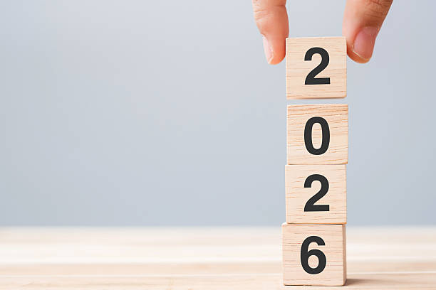 istock hand holding wooden cube block with 2026 text on table background. Resolution, plan, review, goal, start and New Year holiday concepts 2226898069