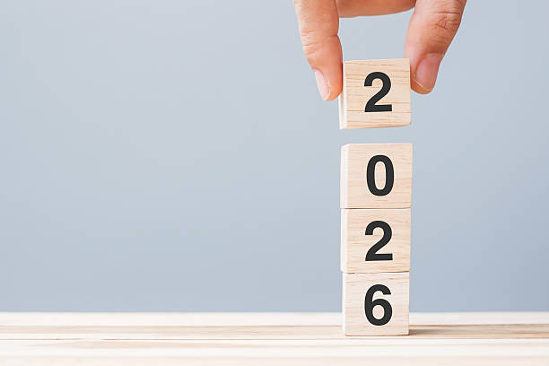 istock hand holding wooden cube block with 2026 text on table background. Resolution, plan, review, goal, start and New Year holiday concepts 2226898070