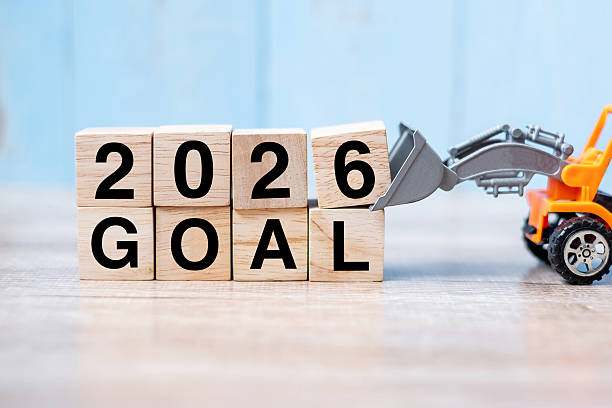 istock 2026 goal cube blocks with miniature truck or construction vehicle. New Start, Vision, Resolution, goal, industrial, Warehouse and happy New Year concept 2226898083