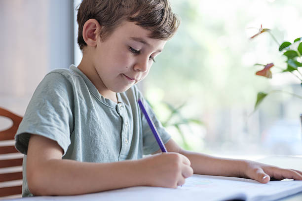 istock Little child boy doing her homework at home 2226898550