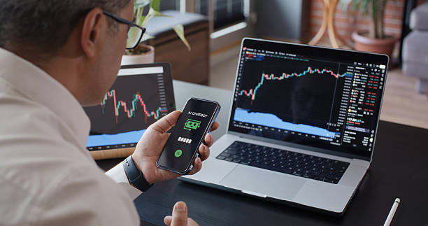 istock Man using AI Chatbot while checking his stock market exchange investment with TradingView on laptop computer 2226898553