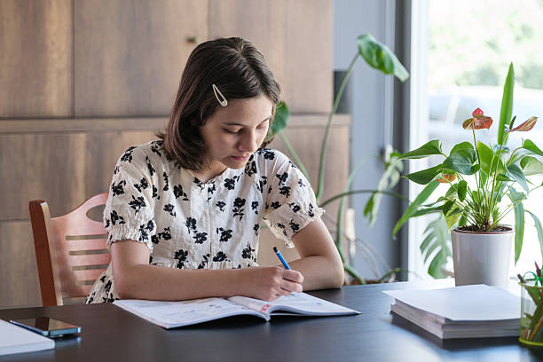 istock Adolescence girl doing her homework at home 2226899638
