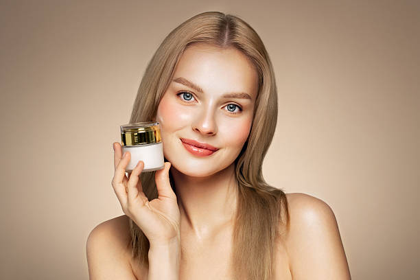 istock Beauty woman applying cream on her face 2226899835