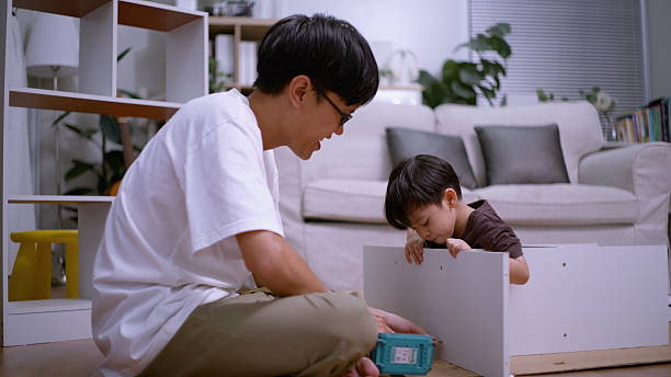 istock Father and Son Teamwork Setting Up Storage Shelf Indoors. 2226902138