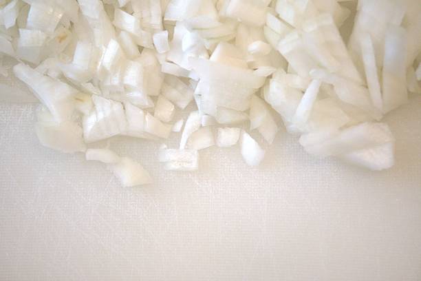 istock Chopped onion on white plastic cutting board, close-up 2226905920
