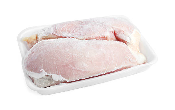 istock Frozen chicken breasts in container isolated on white 2226910948
