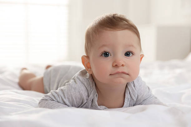 istock Cute little baby on bed at home 2226911517